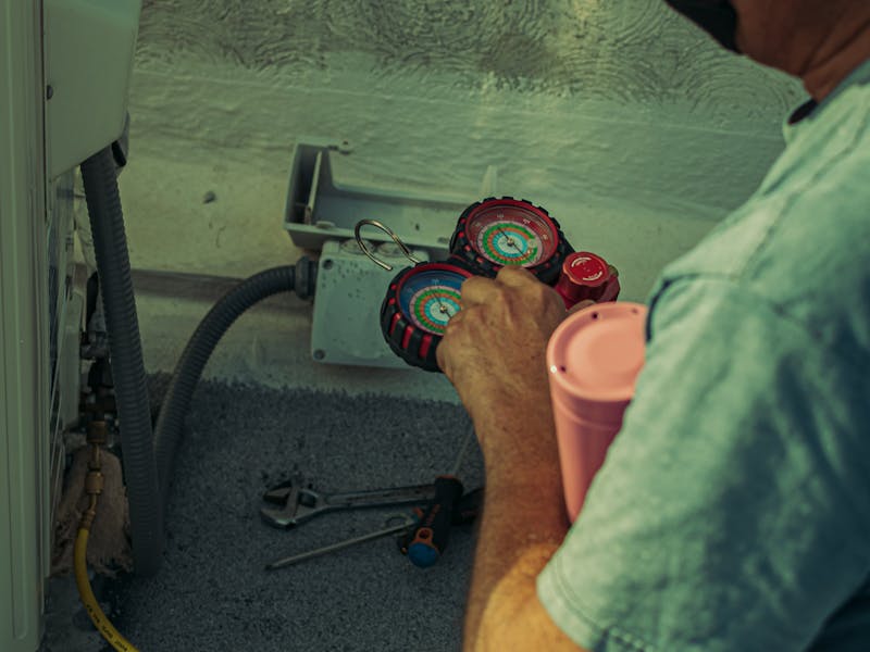 HVAC technician troubleshooting heating system with diagnostic tools